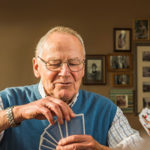 three people playing cards