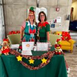 Two Staff Members at Table for Christmas Celebration